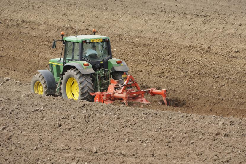 A tractor ploughing the soil