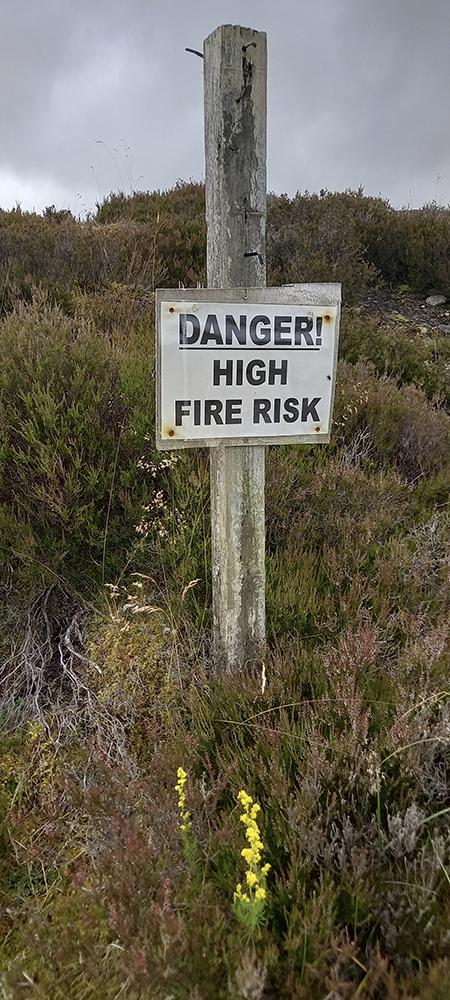 High fire risk sign in area covered with heather