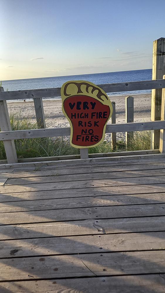 Sign attached to fence saying 'very high fire risk, no fires'