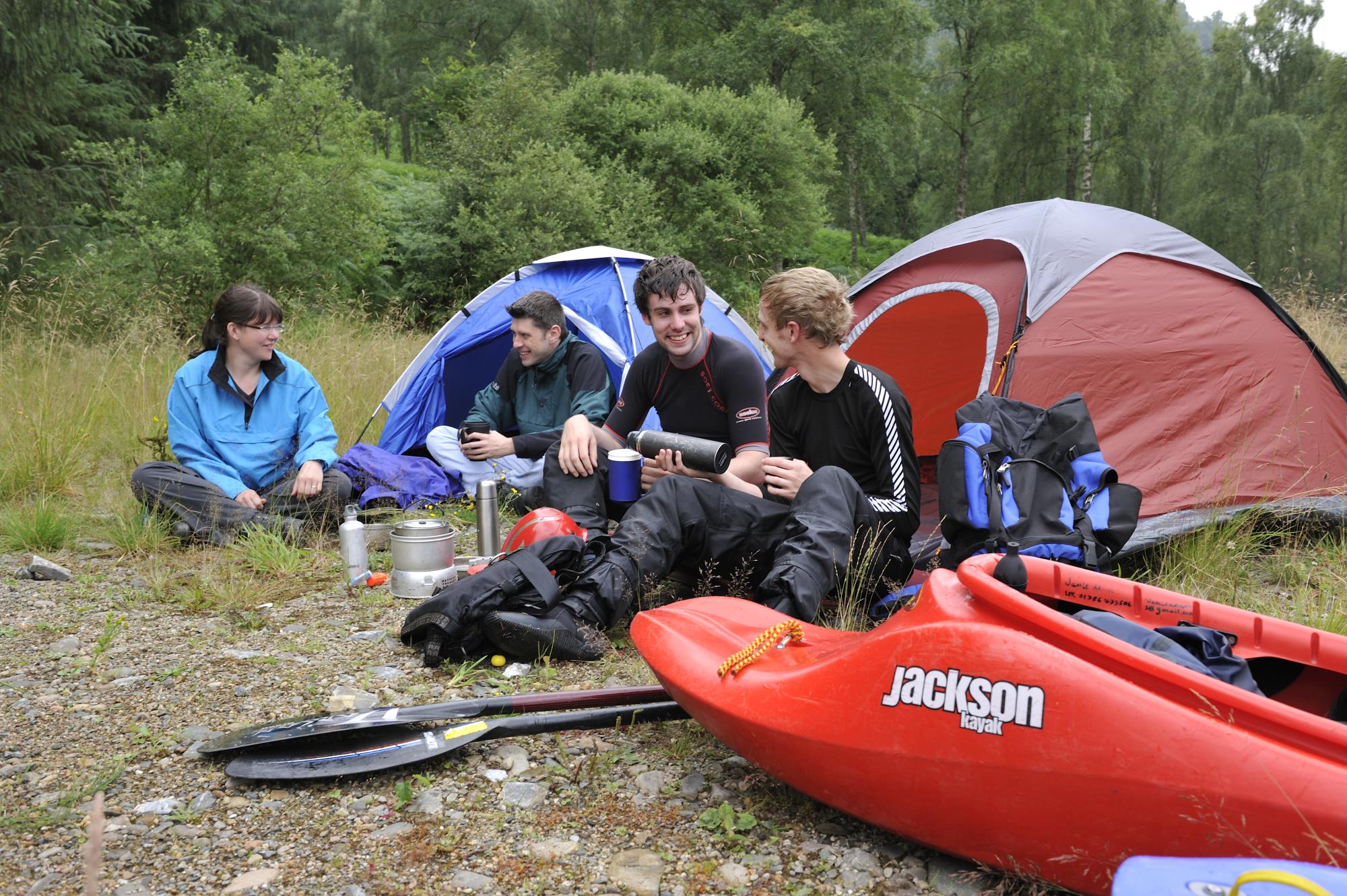 Campers with canoes outside tent at Loch Tummel.
